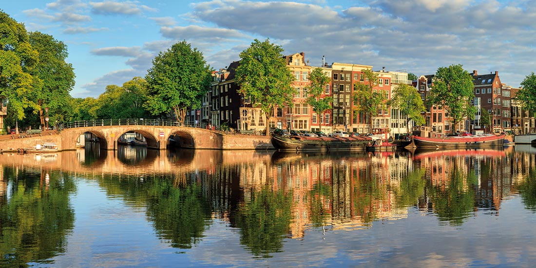 Gable houses lining the Amstel River in Amsterdam, Netherlands